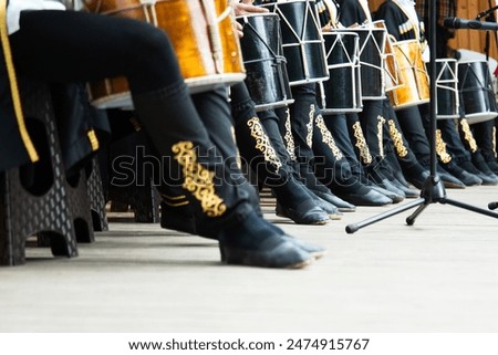 Low angle view of drummers playing on national ossetian drums .