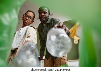 Low angle view at father and son sorting household waste at home together, recycling bin POV - Shutterstock ID 2111469506