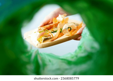 Low angle view female sorting waste food. Recycling processing food. Sustainable environmental remediation. High quality photo - Powered by Shutterstock