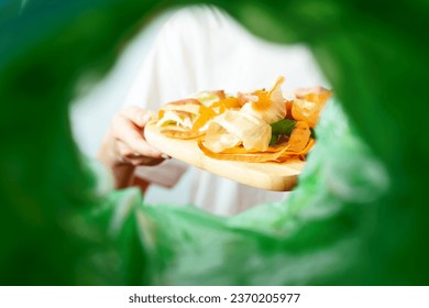 Low angle view female sorting waste food. Recycling processing food. Sustainable environmental remediation. High quality photo - Powered by Shutterstock