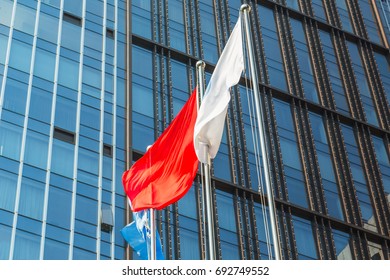 low angle view of flags front of office building.