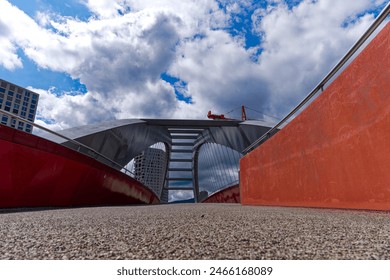 Low angle view of footbridge with arc at industrial district at Swiss City of Zürich on a blue cloudy spring day. Photo taken May 24th, 2024, Zurich, Switzerland. - Powered by Shutterstock