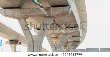 Low angle view of Foundations Structure of curve Elevated Expressway in under Construction against white lacking sky in the city