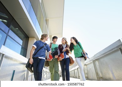 Low Angle View Of Four University Students On Campus