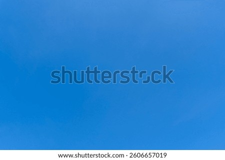 Low angle view and full frame of beautiful light blue sky without clouds in the morning or afternoon on sunny day is used as natural background texture in decorative art work.
