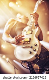 Low angle view of a guitarist on stage at a gig. This concert was created for the sole purpose of this photo shoot, featuring 300 models and 3 live bands. All people in this shoot are model released. - Shutterstock ID 2136957413