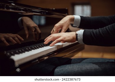 Low angle view of hands of a professional pianist playing piano in a concert or performance. - Powered by Shutterstock