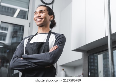 Low Angle View Of Happy African American Barber Standing With Crossed Arms In Grooming Salon,stock Image