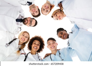 Low Angle View Of Happy Medical Team Forming Huddle