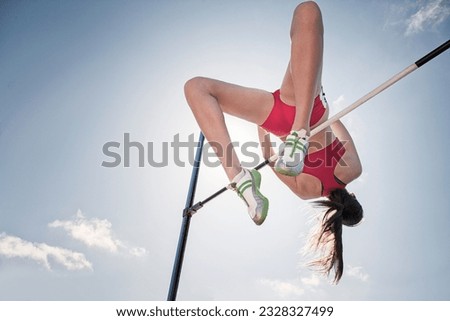 Low angle view high jumper clearing bar