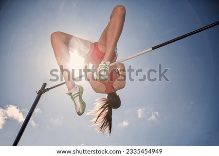 Low angle view high jumper clearing bar