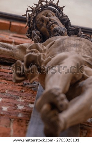 Low angle view of Jesus Christ crucifixion statue with crown of thorns, symbol of sacrifice, suffering, faith and Christianity.