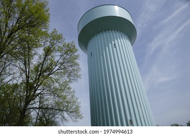 Low Angle View Of Large Water Tower And Tree