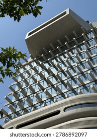 Low angle view looking up at the brutalist and futuristic concrete facade of the HAUS NOWHERE building in Seoul, South Korea. 