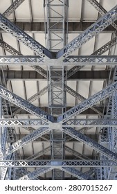 Low angle view looking up at the historic steel truss understructure and maintenance walkways of the Story Bridge in Brisbane, Queensland, Australia