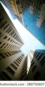 Low angle view looking up at modern skyscrapers and office buildings in a downtown city. Abstract urban architecture background.