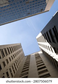 Low angle view looking up at modern skyscrapers and office buildings in a downtown city. Abstract urban architecture background.