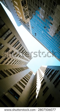Low angle view looking up at modern skyscrapers and office buildings in a downtown city. Abstract urban architecture background.