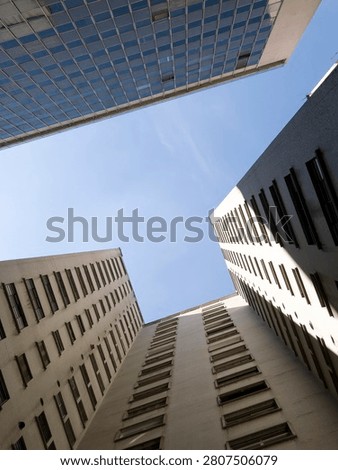 Low angle view looking up at modern skyscrapers and office buildings in a downtown city. Abstract urban architecture background.