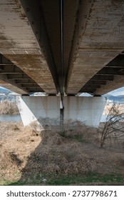 Low angle view looking up at the underside of a concrete bridge