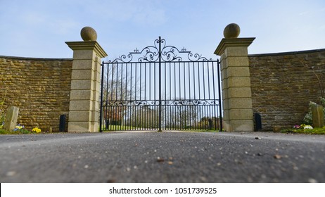 Low Angle View Of A Mansion Gate And Drive 