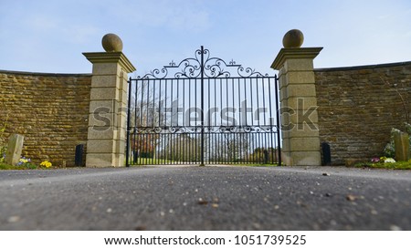 Low Angle View of a Mansion Gate and Drive 