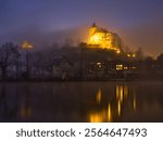 Low angle view of medieval village and castle Werdenberg on a cold, foggy winter night