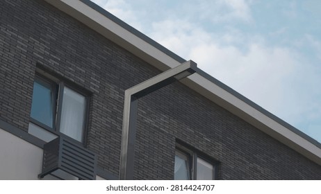 Low Angle View of Modern Brick Building Facade with Streetlight