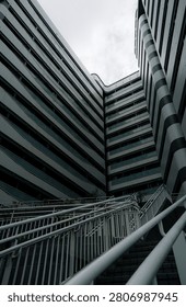Low angle view of modern high rise building and outdoor staircase, urban architecture, business, real estate and city life concept