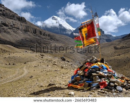 low angle view of mount kailash with tibetan mani stone pile and prayer flags, tibet, china