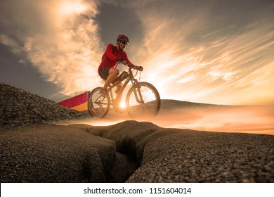 Low Angle View Mountain Bike Cyclist Cycling On The Hill Mountain Twilight Time On Top Of A Mountain , Extreme Sport Concept.