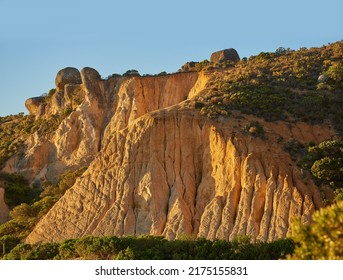 Low angle view of a mountain peak in South Africa. Scenic landscape of a remote hiking location on Lions Head in Cape Town at sunset on a sunny day. Travelling and exploring nature through adventure