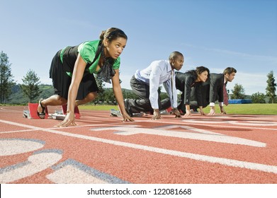 Low Angle View Of Multi Ethnic Business People At Starting Position On Race Track