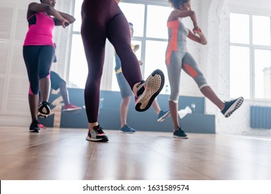 Low angle view of multicultural dancers practicing zumba in dance studio - Powered by Shutterstock