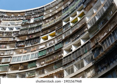 Low angle view of narrow apartments crowded in a semi-circular high-rise residential building in Guomao Community (果貿社區), which is an old public housing estate in Zuoying District, Kaohsiung, Taiwan