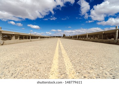 Low Angle View Of Old Abandoned Highway With A Beautiful Blue Sky