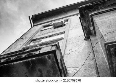 Low angle view of the old but beautiful yellow building in the center of the city. Black and white photograph.