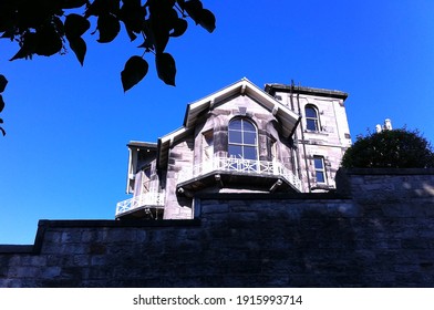 low angle view of old stone house against blue sky