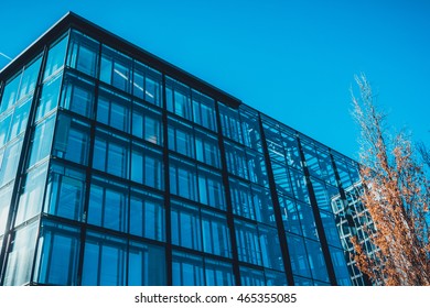 Low Angle View On Energy Efficient Office Building Exterior With Various Window Shades And Skylights