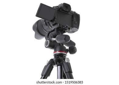 Low angle view on massive black still-shot camera on trepied cutout