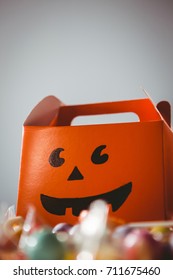 Low Angle View Of Orange Box With Anthropomorphic Smiley Face Against White Background