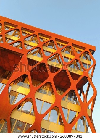Low angle view of the orange and yellow futuristic facade of a building in luxembourg city 