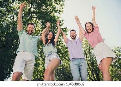 Low angle view photo of happy brown haired men and women hold raise hands fists winner free vacation summer outside in outdoors - Shutterstock ID 1848688582