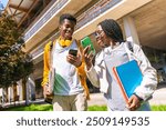 Low angle view photo of male and female african american university friends using phones walking along the campus