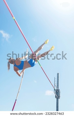 Low angle view pole jumper clearing bar