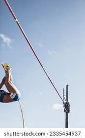 Low angle view pole vaulter nearing bar