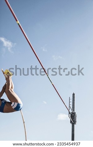 Low angle view pole vaulter nearing bar