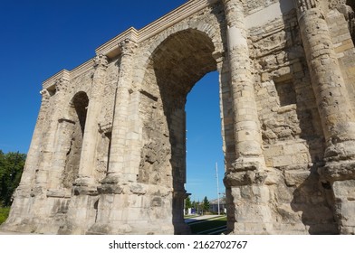Low angle view of the Porte de Mars (Gate of Mars), a 3th century vestige, and an ancient Roman triumphal arch, located at the end of the Hautes Promenades, in Reims, in the Northeast of France - Shutterstock ID 2162702767