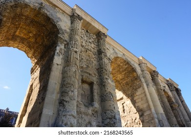 Low angle view of the Porte de Mars (Gate of Mars), a 3th century vestige, and an ancient Roman triumphal arch, located at the end of the Hautes Promenades, in Reims, in the Northeast of France - Shutterstock ID 2168243565