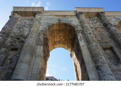 Low angle view of the Porte de Mars (Gate of Mars), a 3th century vestige, and an ancient Roman triumphal arch, located at the end of the Hautes Promenades, in Reims, in the Northeast of France - Shutterstock ID 2177085707